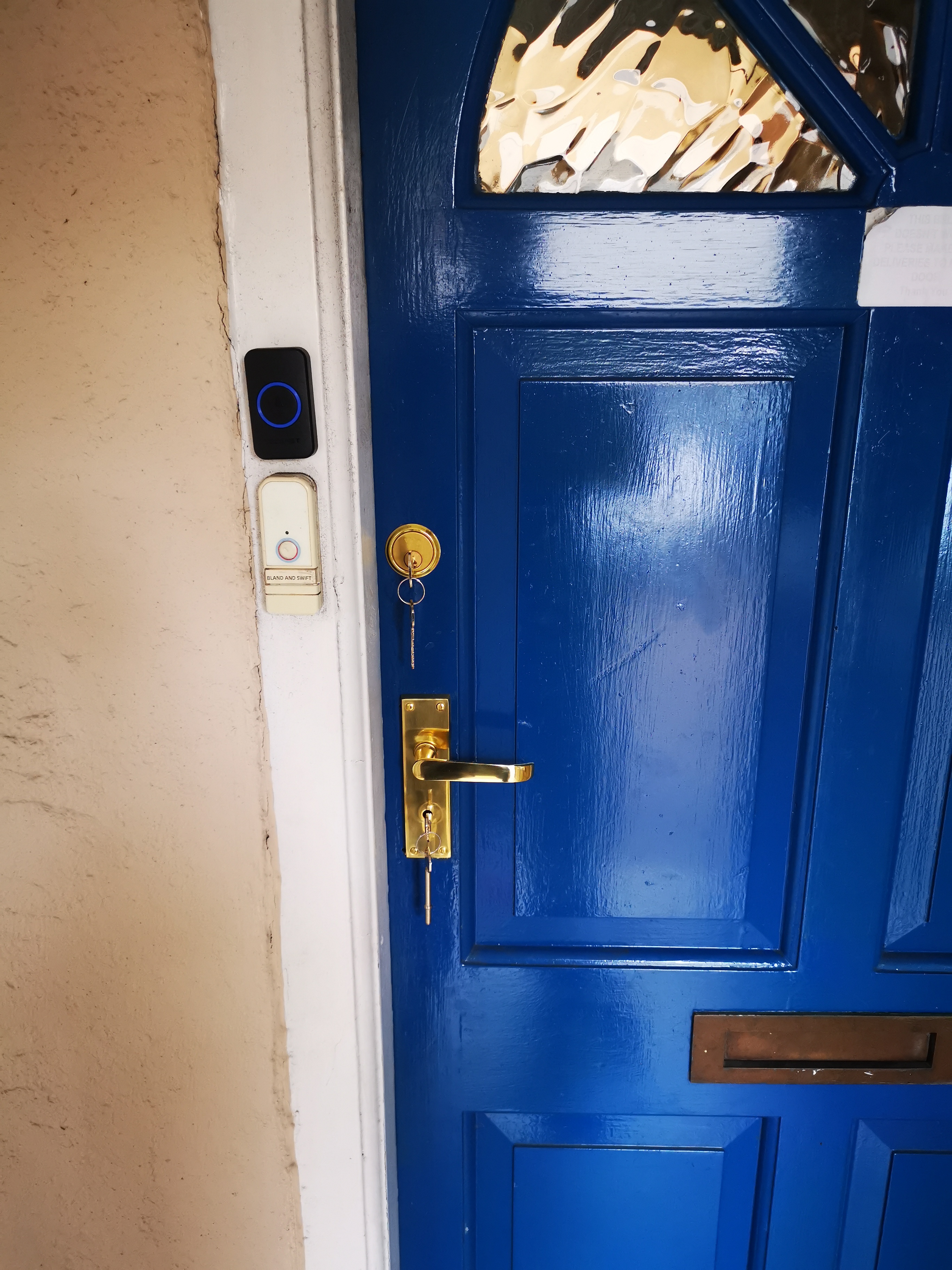 keyed alike mortice and yale locks on blue wooden door with gold fittings