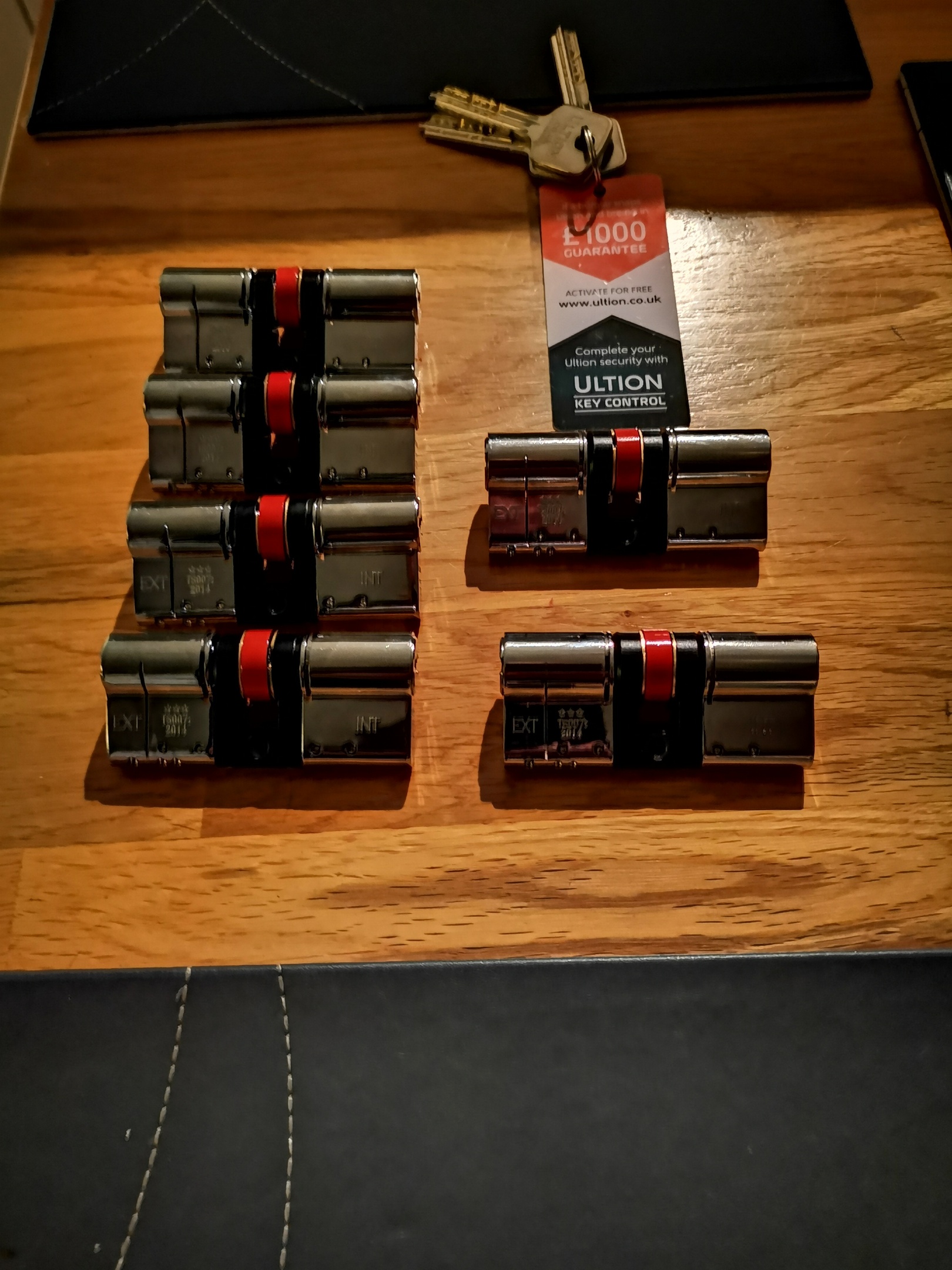 6 x master keyed euro cylinders laid on wooden oak table