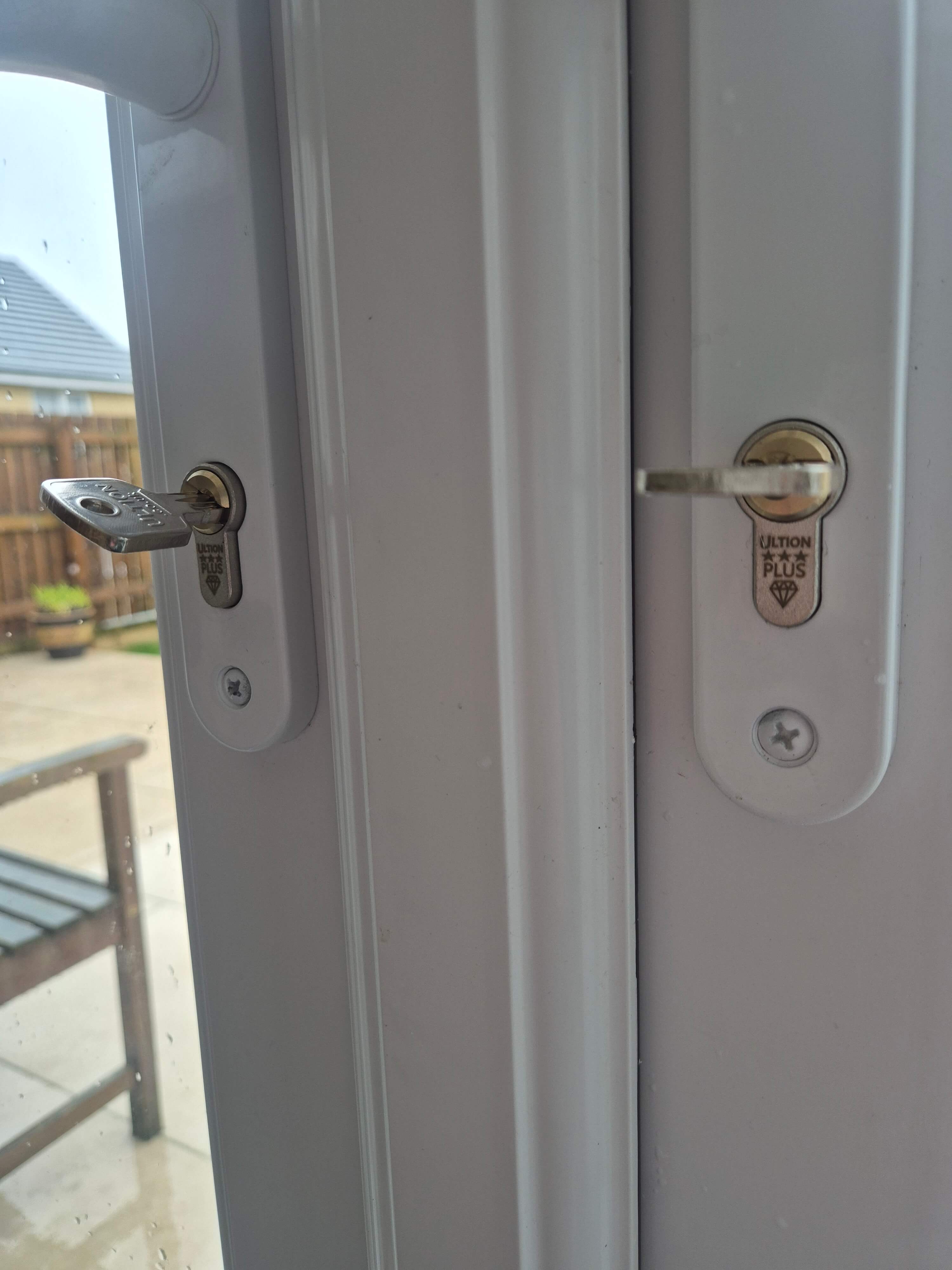 2 x anti snap locks fitted to white french doors showing security rating and keys
