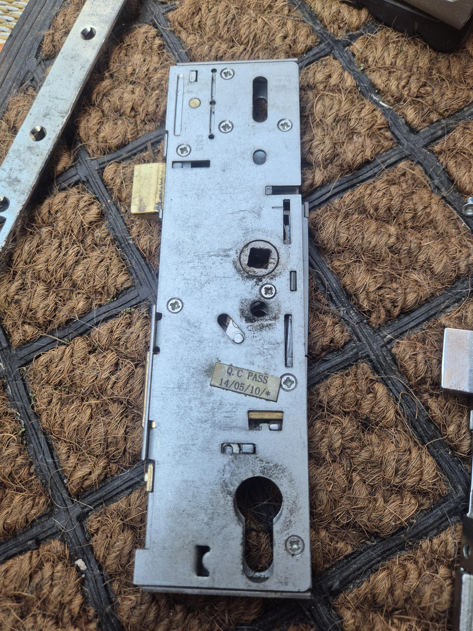 Faulty Era composite door gearboxes laid on brown door mat