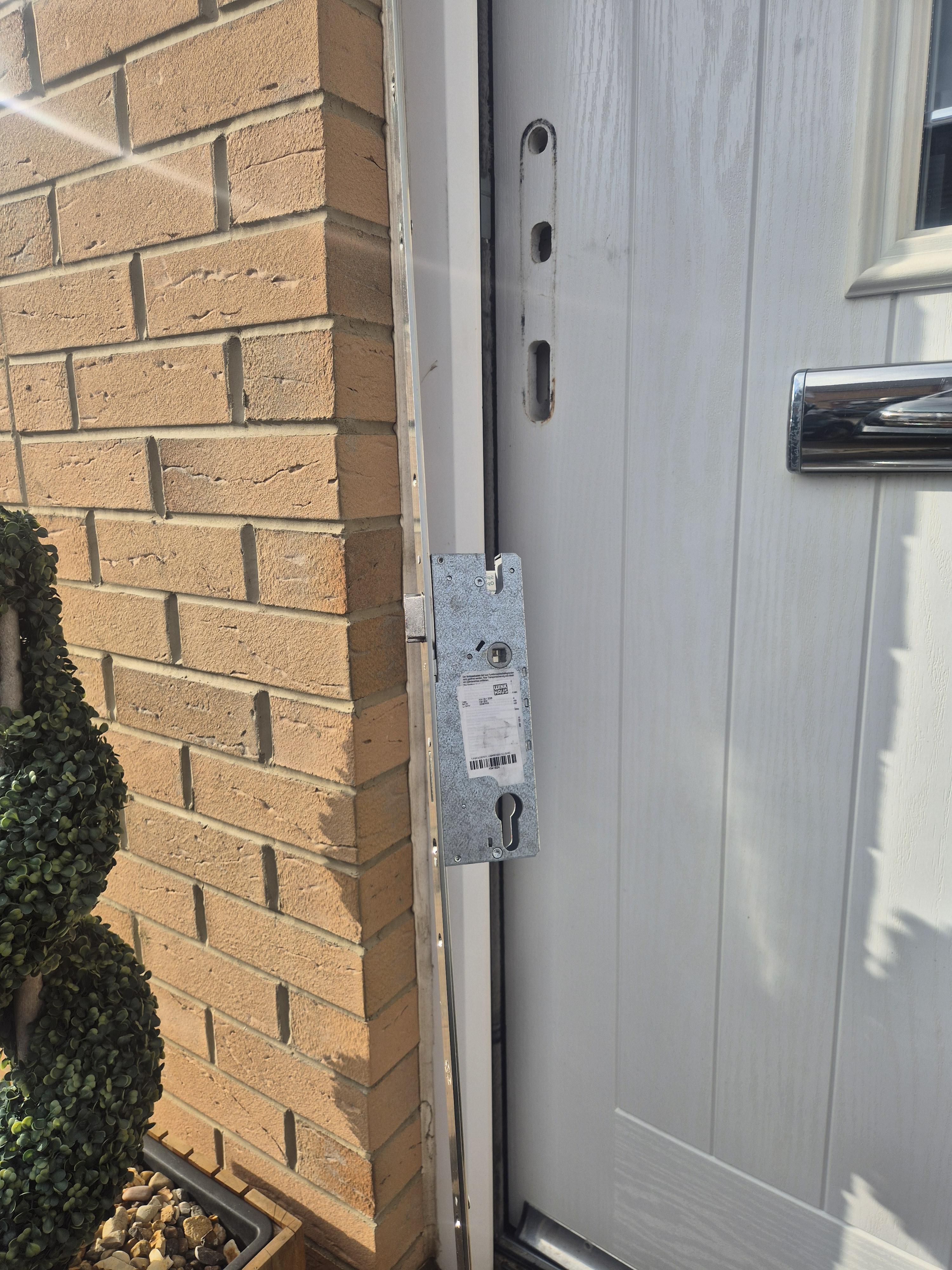 Winkhaus multi point lock being fitted in Kirkstall showing lock strip and white door