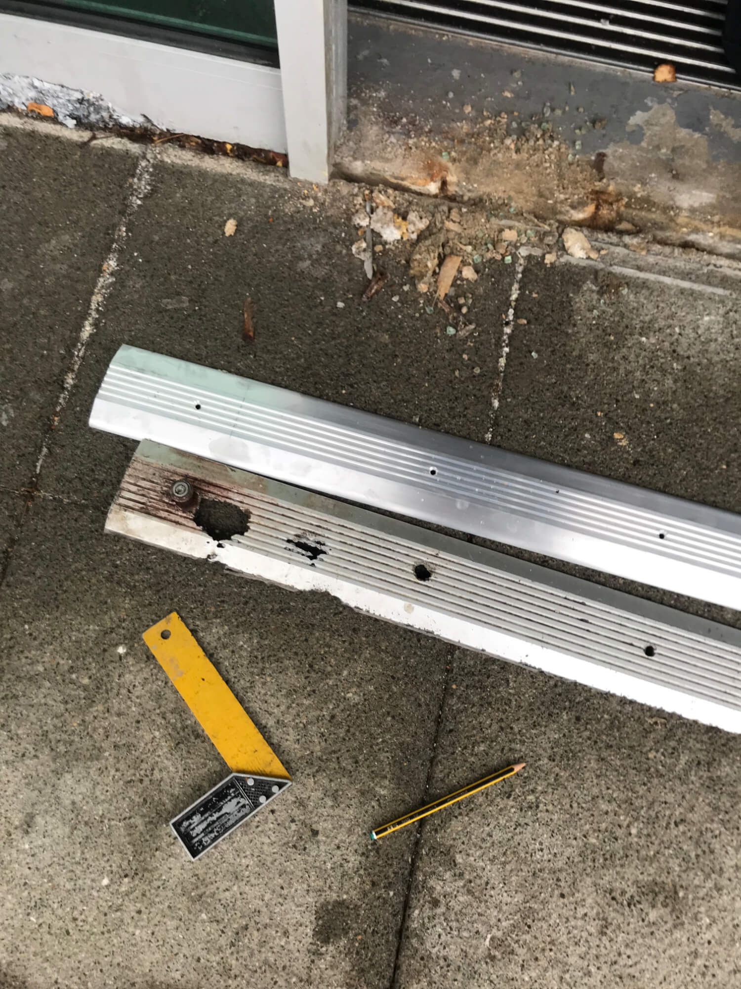 Commercial door cill showing old and new in stainless steel