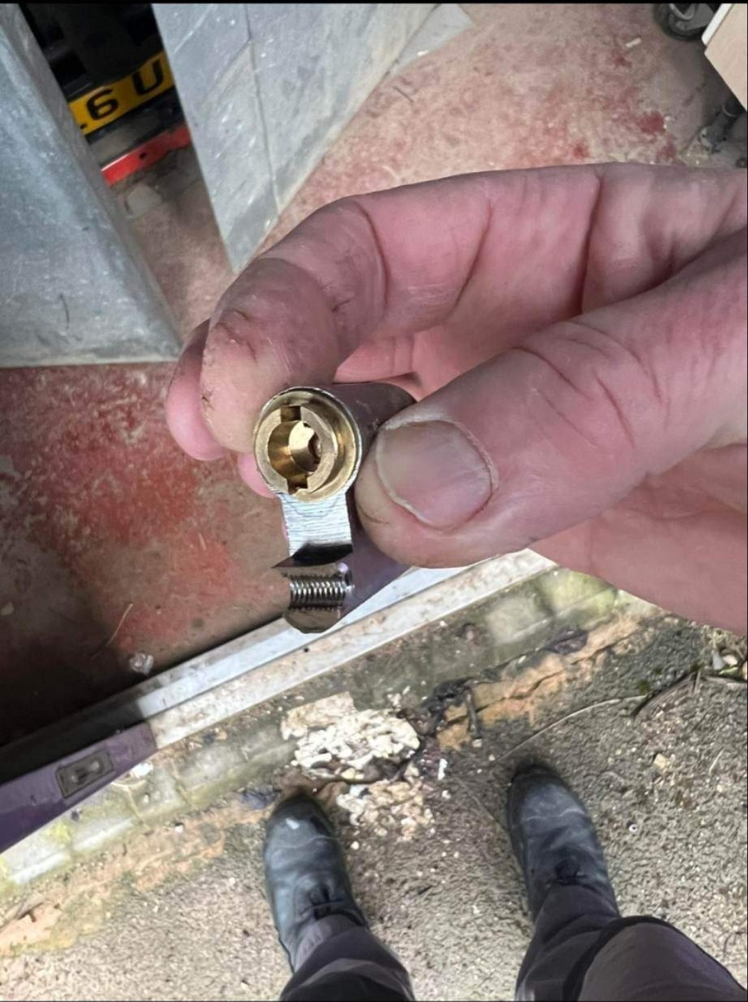 Half of snapped euro lock being held in hand showing centre section