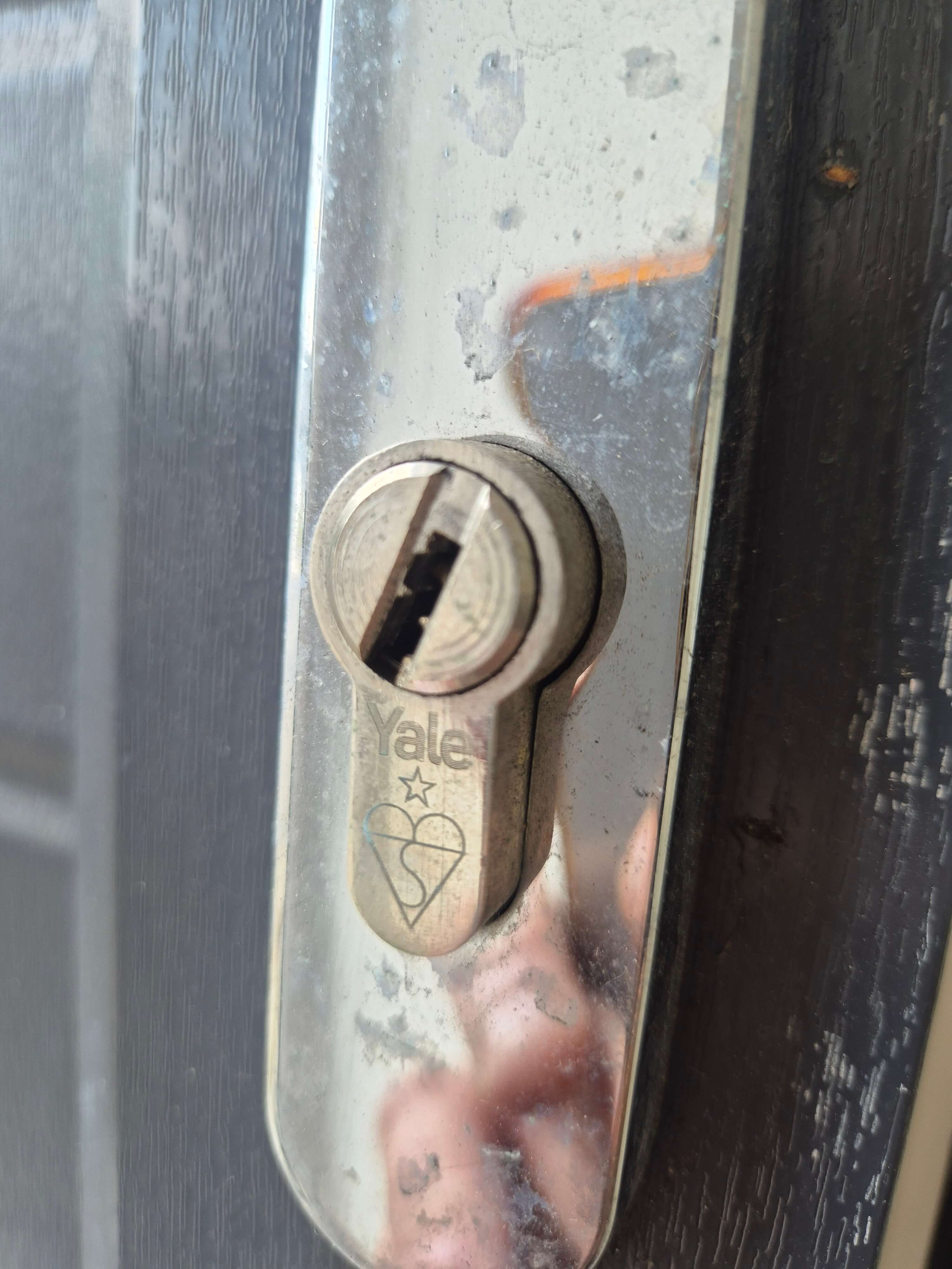 Gain entry to Yale 1 star on a black door with chrome handle