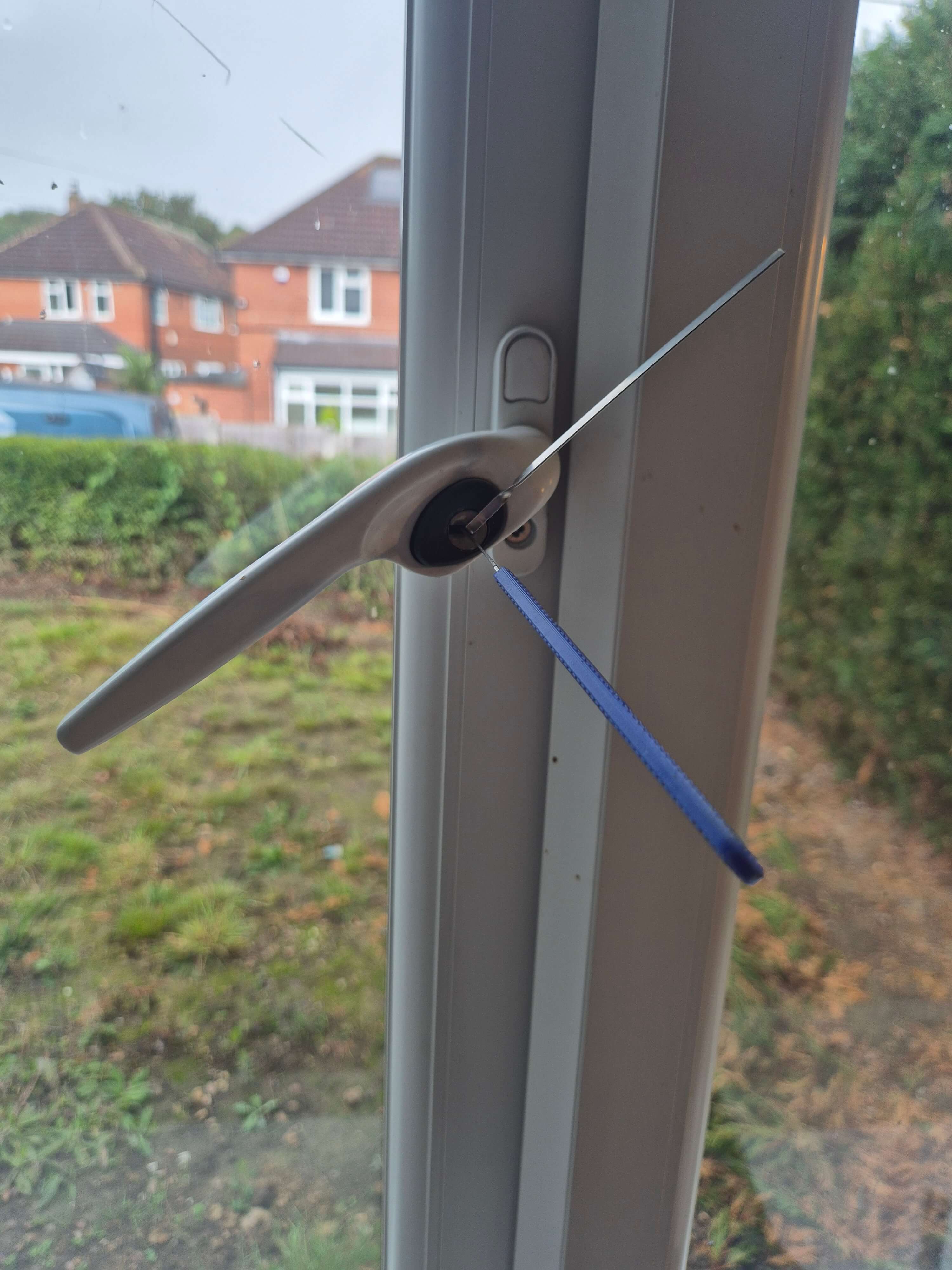 window handle picked open with tension tool and blue lock pick