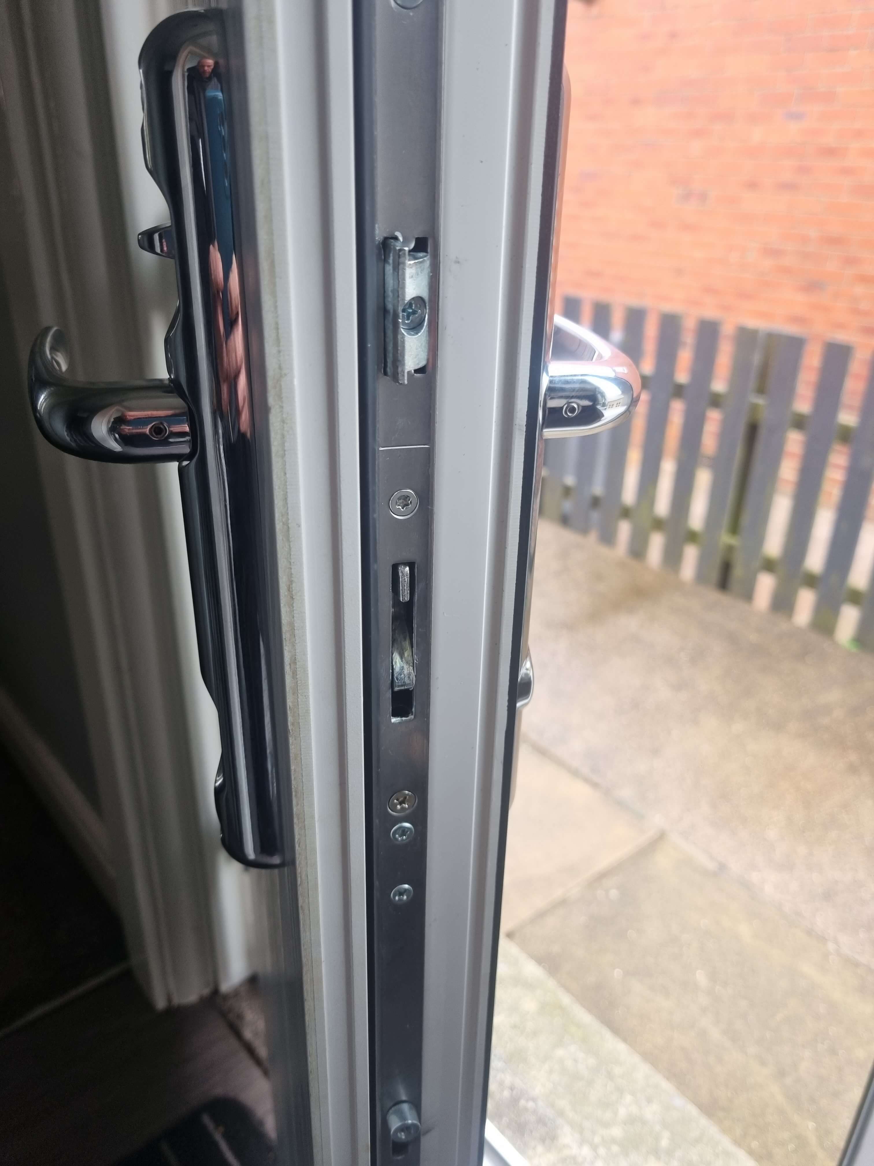 Composite door locking mechanism