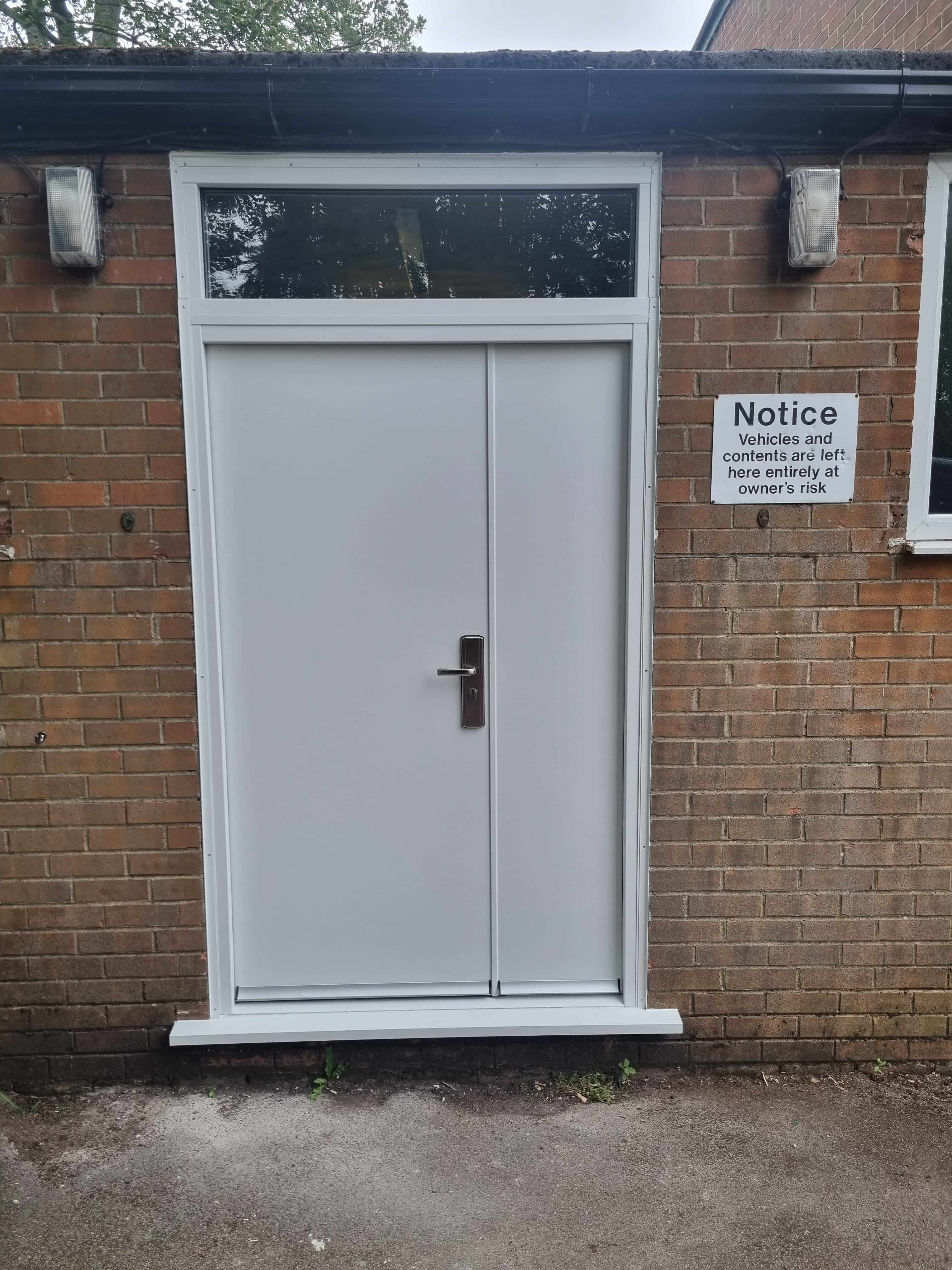 New high security steel double doors in white with glass panel