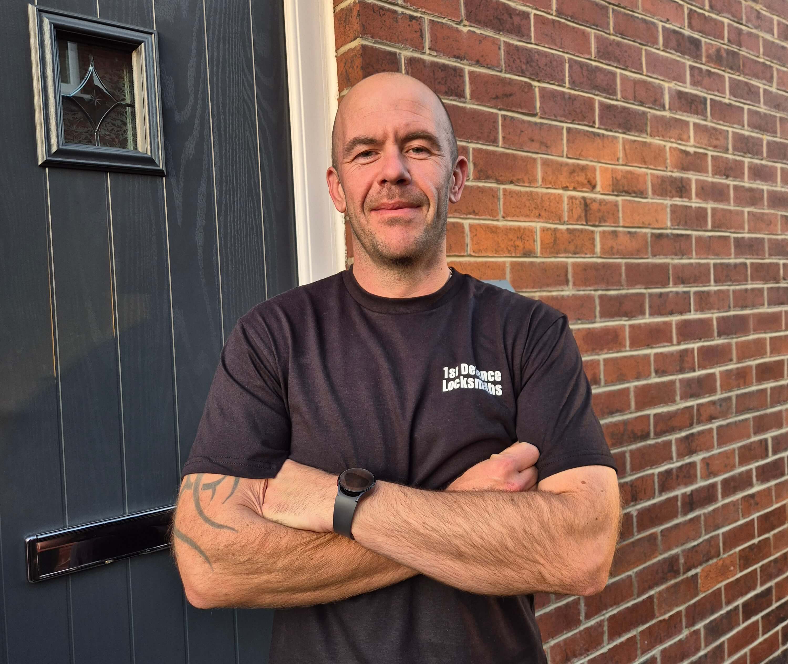 Ben Gatenby Owner of 1st Defence Locksmiths Leeds wearing branded black t shirt